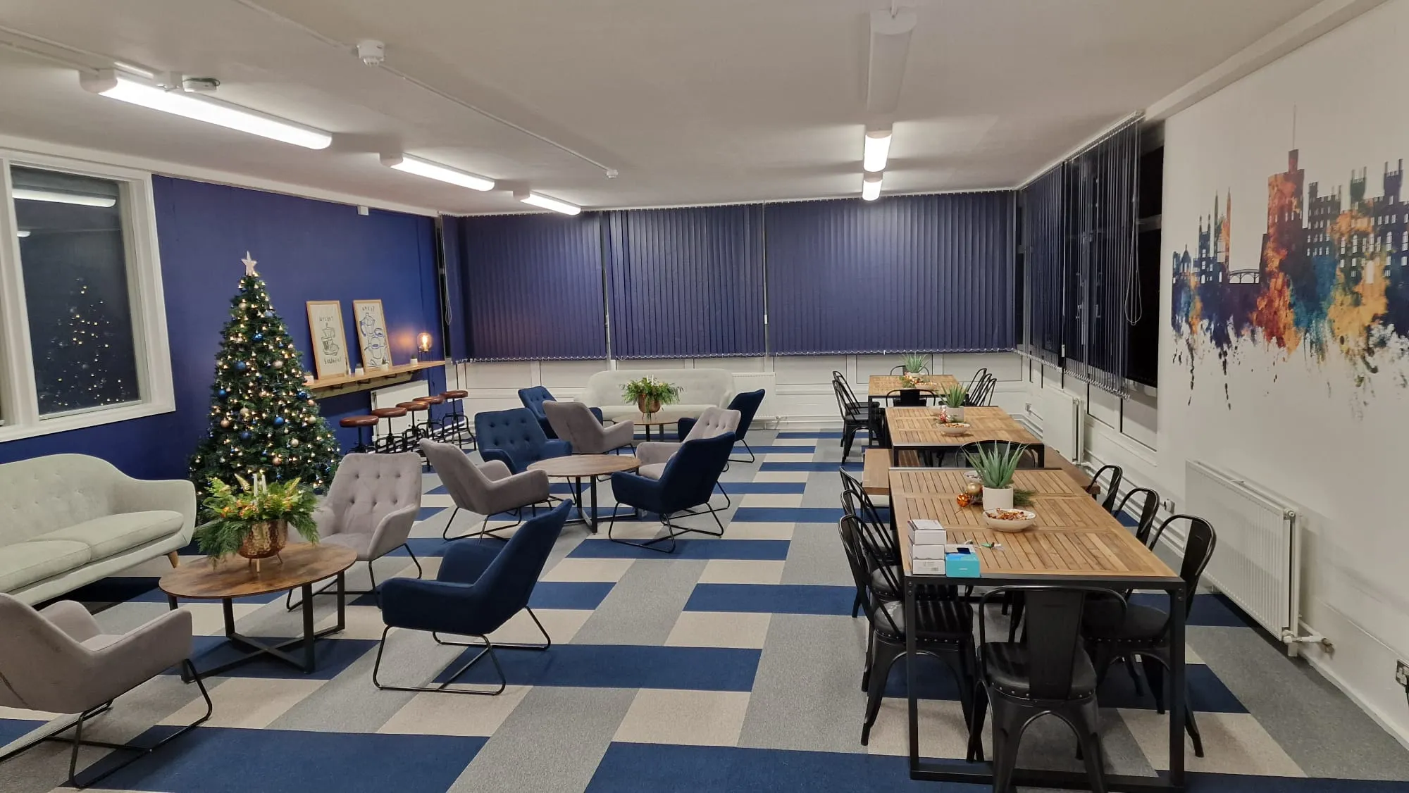 A room with tables, chairs, and a christmas tree.