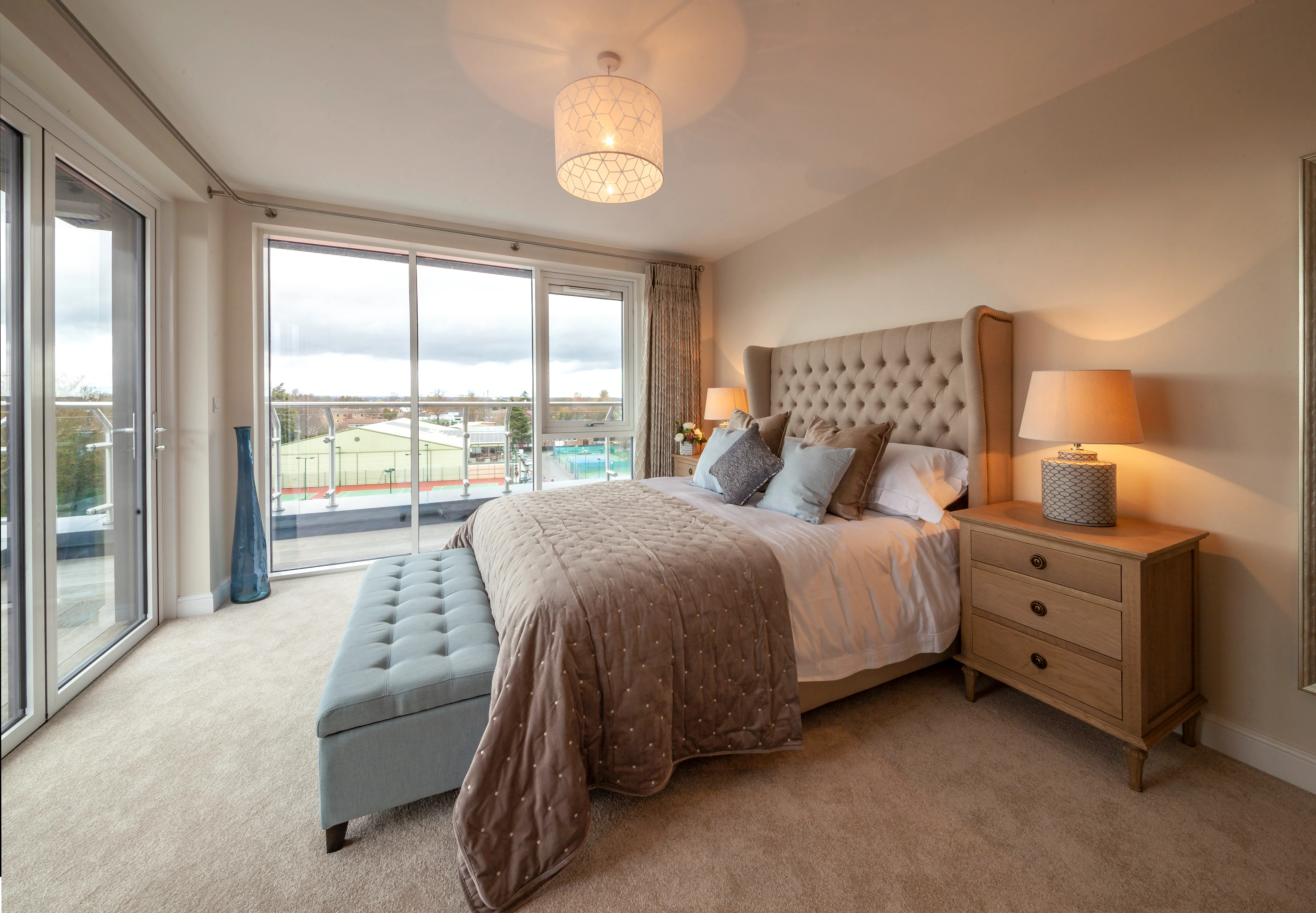 A bedroom with a large bed and a large window.