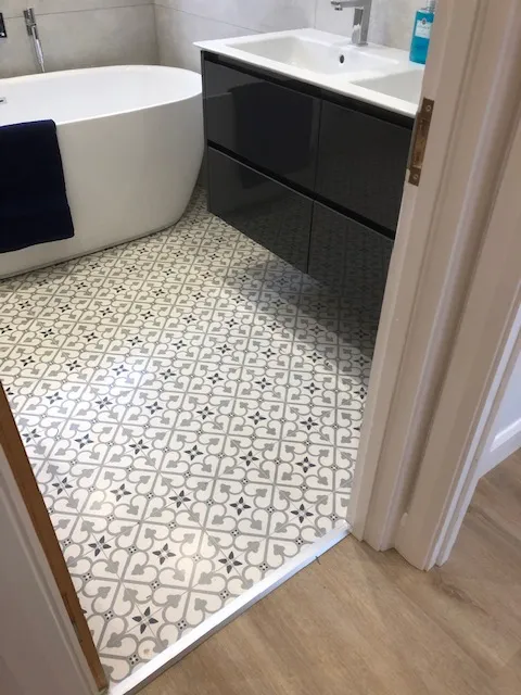 A bathroom with a bathtub, sink, and toilet.