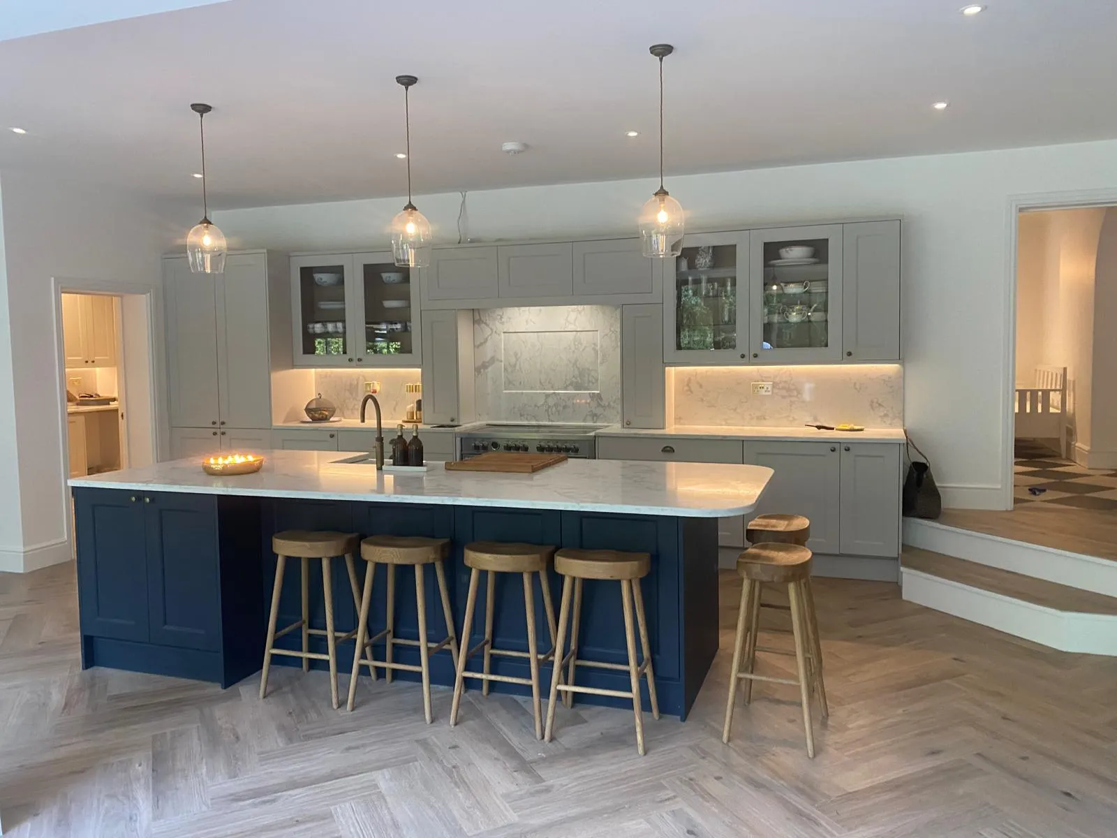 A kitchen with a center island with stools.
