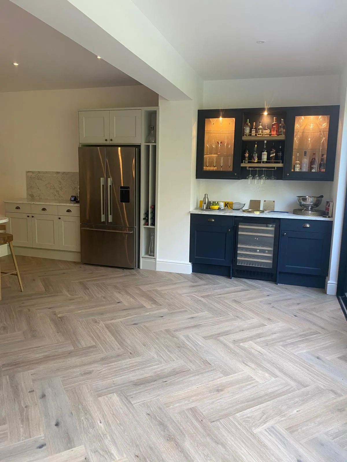 A kitchen that has a refrigerator and a table in it.