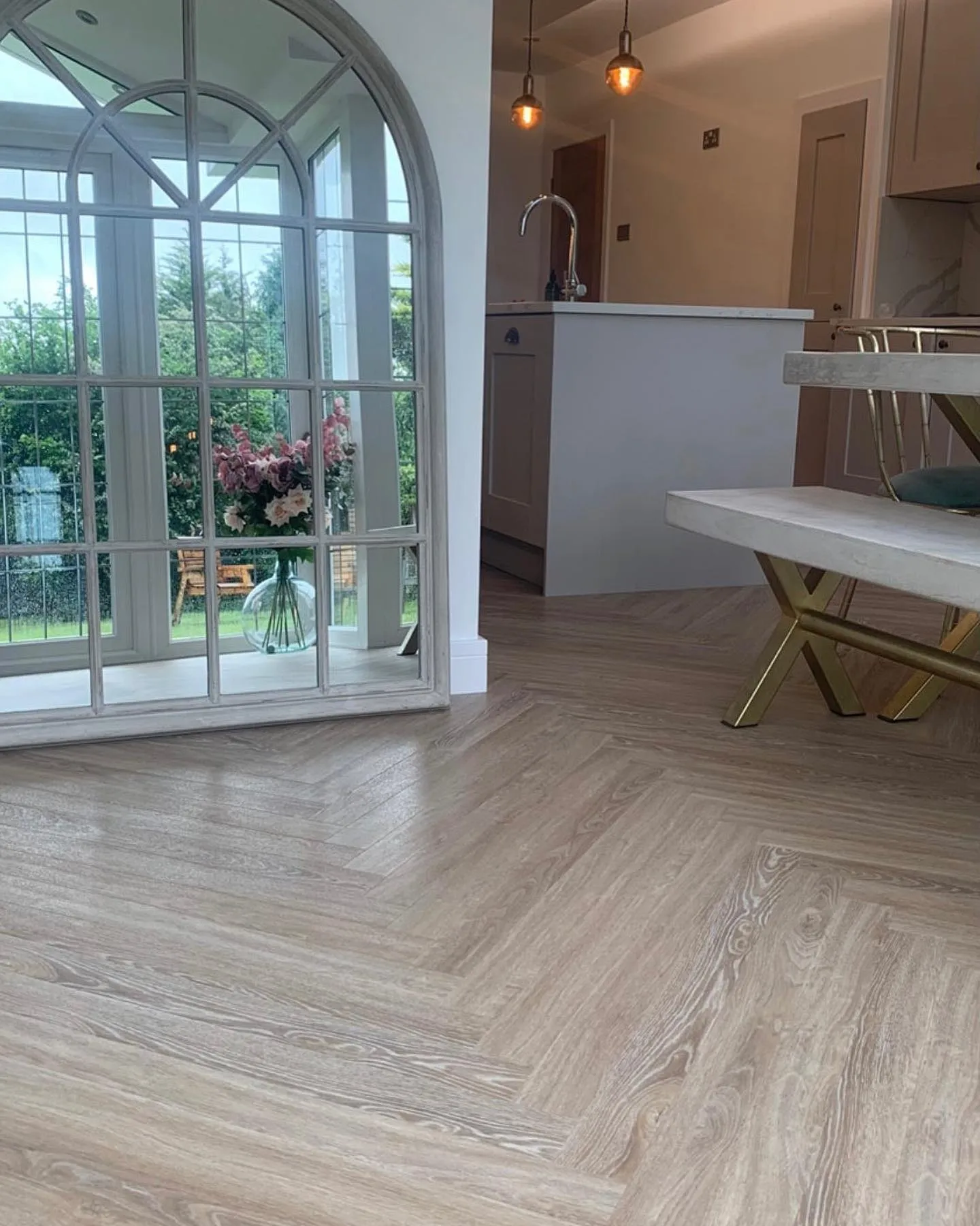 A room with a large window and a bench.