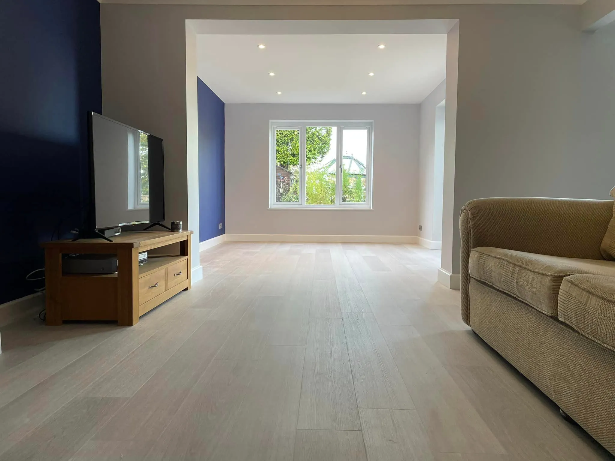 A living room with a couch and a television.
