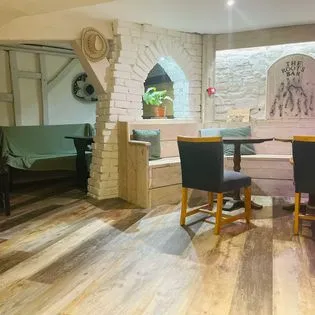 A dining room with a table and chairs.