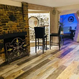 A living room filled with furniture and a fire place.
